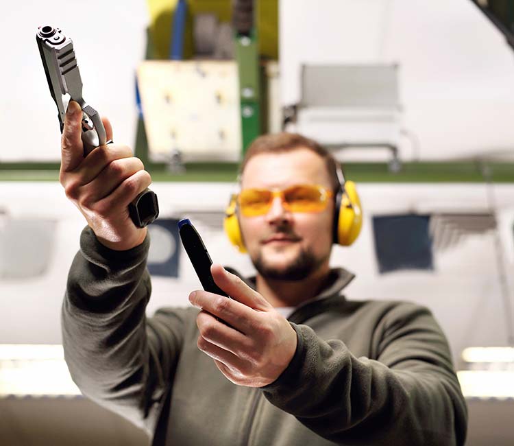 Male student learning to load a handgun at 3B Tactical range in Miami, FL