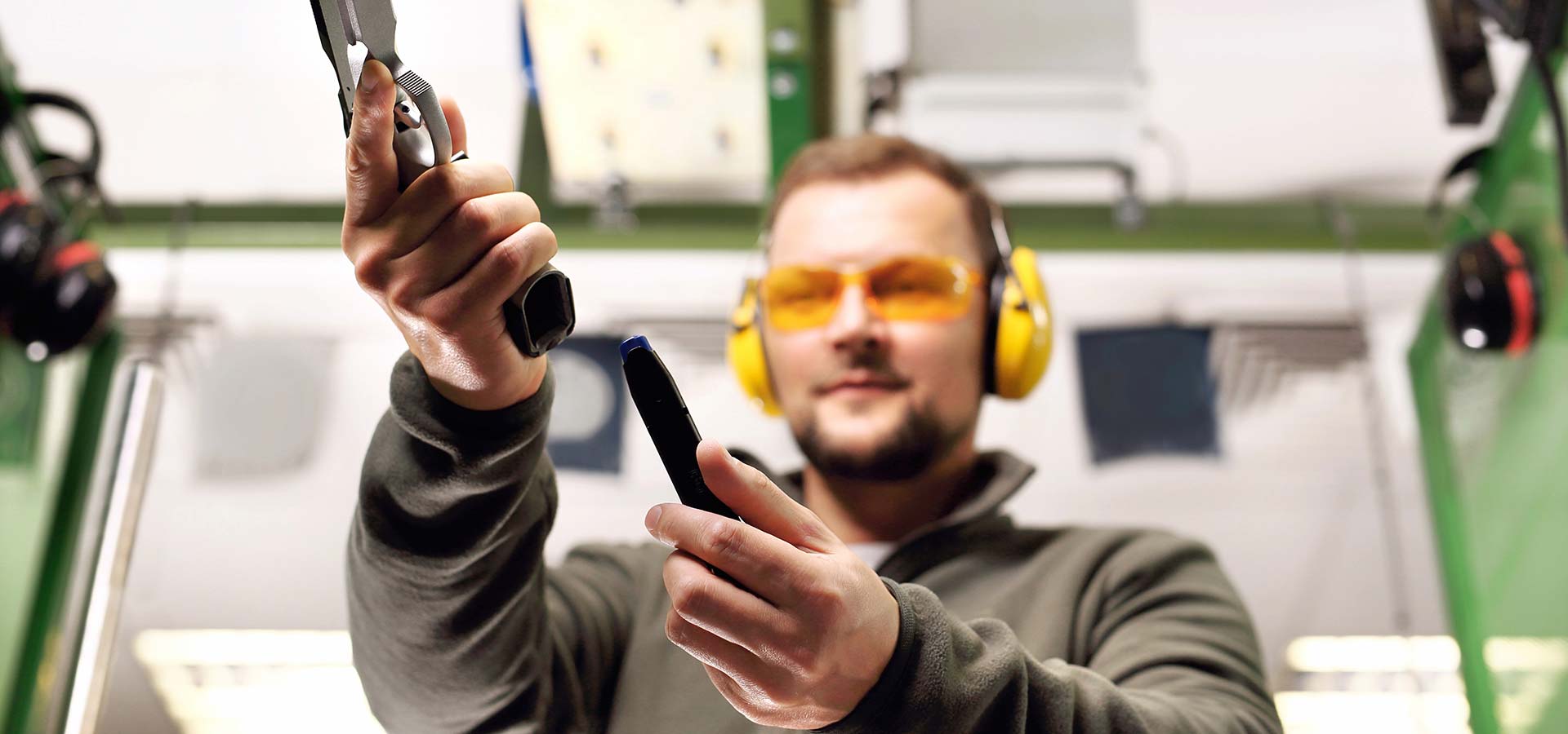 Male student learning to load a handgun at 3B Tactical range in Miami, FL