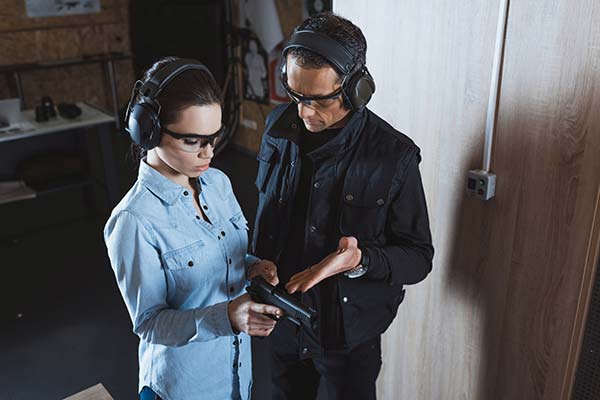 Instructor guiding a trainee on firearm usage at 3B Tactical training facility in Tulsa, OK