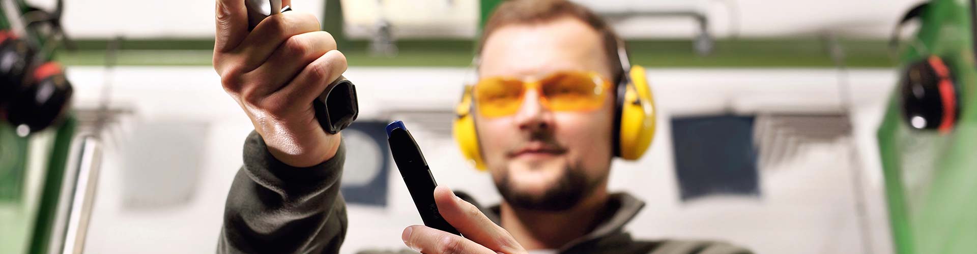 Male student learning to load a handgun at 3B Tactical range in Miami, FL