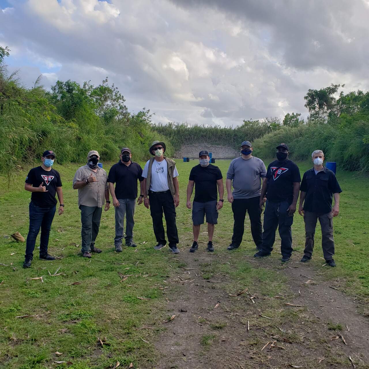 Group of trainees and instructors standing together at the outdoor shooting range at 3B Tactical in Miami, FL