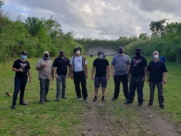 Group of trainees and instructors standing together at the outdoor shooting range at 3B Tactical in Miami, FL