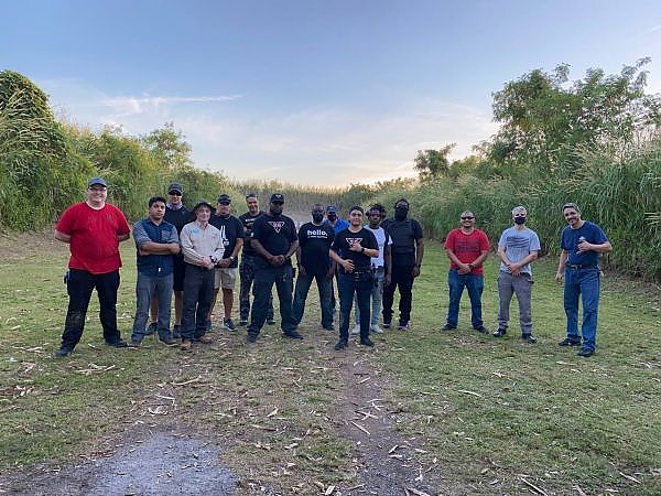 Group of trainees and instructors posing together at the shooting range at 3B Tactical in Miami, FL